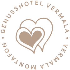 Logo des GenussHotels Vermala mit zwei sich überlappenden Herzumrissen in Beige, umgeben vom Schriftzug „GENUSSHOTEL VERMALA VERMALA MONTAFON” in Großbuchstaben.